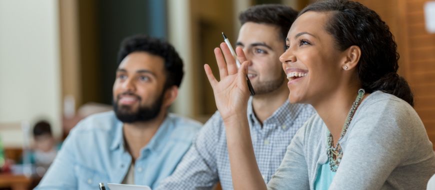 Two men and a woman sat in a classroom