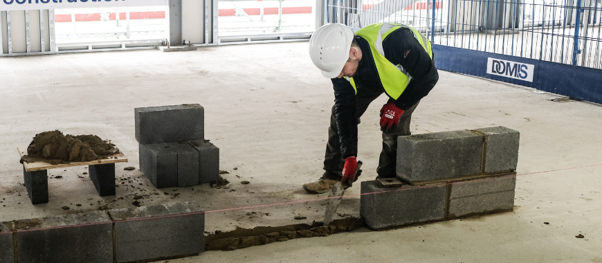 A brick layer building an internal wall