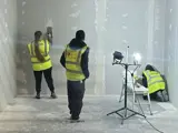 Three construction workers boarding a room