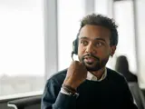 A young man wearing a headset in an office