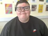 A portrait of a young person wearing glasses