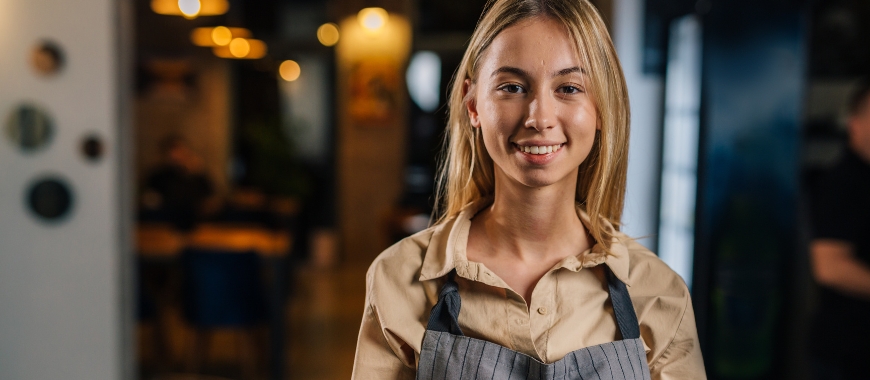 A young woman wearing an apron